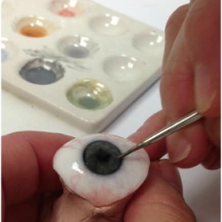 Photo of an eye prosthesis being hand painted
